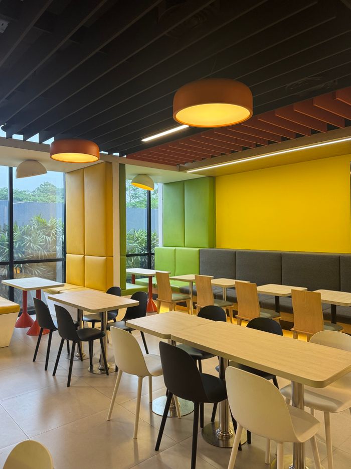 Bright and modern cafeteria interior with colorful seating and lighting in Dhaka, Bangladesh.